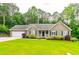 Charming single-story home features a well-manicured lawn and attached two car garage at 2430 Tribble Creek Cv, Grayson, GA 30017