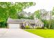 Attractive home has a lush lawn, side driveway, and an attached two car garage at 2430 Tribble Creek Cv, Grayson, GA 30017