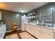 This basement kitchen is complete with white appliances, granite countertops, and ample cabinet storage at 2430 Tribble Creek Cv, Grayson, GA 30017