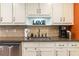 Kitchen sink features granite countertops, stainless appliances, and stylish backsplash at 2430 Tribble Creek Cv, Grayson, GA 30017