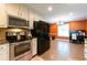 Bright kitchen featuring stainless steel appliances and a cozy dining nook at 2430 Tribble Creek Cv, Grayson, GA 30017