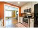 Charming kitchen with stainless steel appliances leading to bonus room at 2430 Tribble Creek Cv, Grayson, GA 30017