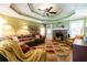 Inviting living room with stone fireplace, plush seating, and trey ceiling with fan at 2430 Tribble Creek Cv, Grayson, GA 30017