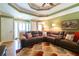 Comfortable living room with a large sofa, modern lighting, and ceiling fan at 2430 Tribble Creek Cv, Grayson, GA 30017