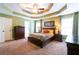 Inviting main bedroom with tray ceilings, neutral walls and carpet, and plenty of space at 2430 Tribble Creek Cv, Grayson, GA 30017
