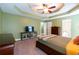 Main bedroom with tray ceilings, neutral walls and carpet, with abundant natural light and closet space at 2430 Tribble Creek Cv, Grayson, GA 30017