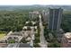 An aerial shot featuring buildings and foliage in the neighborhood with street view and blue skies overhead at 2734 Peachtree Nw Rd # C-404, Atlanta, GA 30305