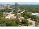 An aerial view showcasing the neighborhood, church, tall buildings, trees, and surrounding greenery at 2734 Peachtree Nw Rd # C-404, Atlanta, GA 30305