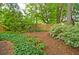 A backyard oasis featuring manicured garden beds, lush greenery, and comfortable seating area at 2734 Peachtree Nw Rd # C-404, Atlanta, GA 30305