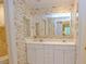 Bathroom with double sink vanity, mirror, and floral wallpaper adding a decorative touch at 2734 Peachtree Nw Rd # C-404, Atlanta, GA 30305