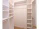 Organized walk-in closet with custom shelving and ample storage space at 2734 Peachtree Nw Rd # C-404, Atlanta, GA 30305