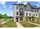 Attractive townhome showcasing modern architecture, neat landscaping, and a welcoming entrance at 449 Breccia Run, Mcdonough, GA 30253