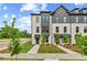 Charming townhomes with modern design elements, including brick facades, black window frames, and well-maintained landscaping at 449 Breccia Run, Mcdonough, GA 30253