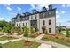 View of elegant townhomes featuring landscaped yards and sidewalks, in a well-maintained community at 449 Breccia Run, Mcdonough, GA 30253