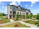 Elegant townhomes featuring landscaped yards and sidewalks, perfect for community living at 449 Breccia Run, Mcdonough, GA 30253