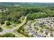Wide aerial view of a lush, green neighborhood. A picture of the house is overlaid on the corner at 5730 Arbor Green Cir, Sugar Hill, GA 30518
