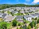 Beautiful aerial view of homes in a well-maintained neighborhood with lush greenery and manicured lawns at 5730 Arbor Green Cir, Sugar Hill, GA 30518
