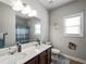 Bathroom featuring a double vanity, white countertops, and modern fixtures at 5730 Arbor Green Cir, Sugar Hill, GA 30518