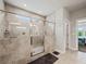 Modern bathroom features large shower with glass enclosure and neutral tiles at 5730 Arbor Green Cir, Sugar Hill, GA 30518