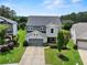Beautiful two-story home featuring a well-manicured lawn and inviting covered front porch at 5730 Arbor Green Cir, Sugar Hill, GA 30518