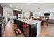 Spacious kitchen with granite counters, stainless appliances, dark cabinets and an open layout to the dining and living areas at 5730 Arbor Green Cir, Sugar Hill, GA 30518