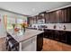 Gourmet kitchen featuring granite countertops, stainless steel appliances, and an island with bar stool seating at 5730 Arbor Green Cir, Sugar Hill, GA 30518