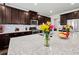 Well-lit kitchen featuring dark cabinets, granite countertops, stainless steel appliances, and a large kitchen island at 5730 Arbor Green Cir, Sugar Hill, GA 30518