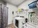 Well-organized laundry room with modern washer and dryer and ample storage space at 5730 Arbor Green Cir, Sugar Hill, GA 30518