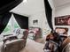 Comfortable living room featuring a massage chair, a sofa, and a cozy interior design at 5730 Arbor Green Cir, Sugar Hill, GA 30518