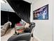 Comfortable living room featuring a massage chair, a sofa, and a cozy interior design at 5730 Arbor Green Cir, Sugar Hill, GA 30518