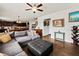 Open-concept living space with dark wood floors, a sectional sofa, view of kitchen, dining area, and staircase at 5730 Arbor Green Cir, Sugar Hill, GA 30518