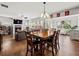 Open-concept living space with wood floors, a fireplace, and access to many different parts of the house at 5730 Arbor Green Cir, Sugar Hill, GA 30518