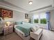 Bright, carpeted bedroom with tray ceiling, green accents, and natural light from backyard view at 5730 Arbor Green Cir, Sugar Hill, GA 30518