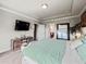 Bedroom with backyard views, TV, and convenient bathroom access at 5730 Arbor Green Cir, Sugar Hill, GA 30518