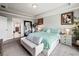 Relaxing bedroom with tray ceiling, decorative art, accent pillows, and neutral furnishings at 5730 Arbor Green Cir, Sugar Hill, GA 30518