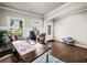Bright and airy home office featuring hardwood floors and natural light streaming through large windows at 5730 Arbor Green Cir, Sugar Hill, GA 30518