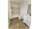 Well-lit bathroom with a tiled floor, bathtub, and vanity at 1225 Creek Forest Nw Ct, Conyers, GA 30012