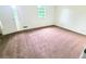 Bright bedroom with neutral carpeting and a window at 1225 Creek Forest Nw Ct, Conyers, GA 30012