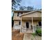 Two story exterior featuring a front porch at 1225 Creek Forest Nw Ct, Conyers, GA 30012