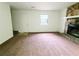 Cozy living room featuring a stone fireplace and neutral carpeting at 1225 Creek Forest Nw Ct, Conyers, GA 30012