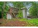 Back of home with stairs leading to a deck, partially surrounded by a wooden fence at 1478 Oxford Ne Rd, Atlanta, GA 30307
