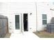Exterior view of the back door with access to a patio and a fenced yard at 1942 Dillon Dr, Lithonia, GA 30058