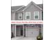 Charming townhome exterior with stone accents and a convenient attached garage at 1942 Dillon Dr, Lithonia, GA 30058