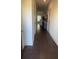 View of long hallway with hardwood floors leading into a living space at 1942 Dillon Dr, Lithonia, GA 30058