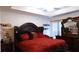Spacious main bedroom with ceiling fan, dark wood furniture, and an abundance of natural light at 1942 Dillon Dr, Lithonia, GA 30058