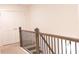 A staircase with a wooden railing and metal balusters, leading to upper level at 1942 Dillon Dr, Lithonia, GA 30058