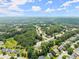 An expansive aerial view of the neighborhood, showcasing the community layout amidst lush greenery at 2605 Fort Apachee Trl, Dacula, GA 30019