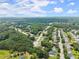 An expansive aerial view of the neighborhood, showcasing the community layout amidst lush greenery and mature trees at 2605 Fort Apachee Trl, Dacula, GA 30019