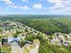 Expansive aerial view showcases the neighborhood's lush greenery and community layout, highlighting the home's location at 2605 Fort Apachee Trl, Dacula, GA 30019