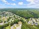 Expansive aerial view showcases the neighborhood's lush greenery and community layout, highlighting the home's location at 2605 Fort Apachee Trl, Dacula, GA 30019